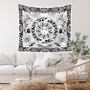 Detail of bohemian sun and moon tapestry with zodiac symbols in a cozy interior