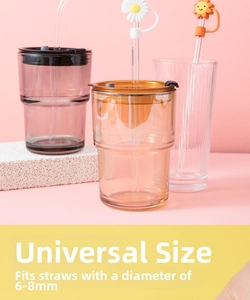 Daisy and sun silicone straw covers for 6-8mm straws on glass cups with pink backdrop