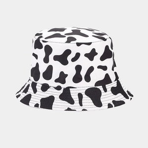 Detail of trendy bucket hat showing premium black and white cow print and high-quality stitching
