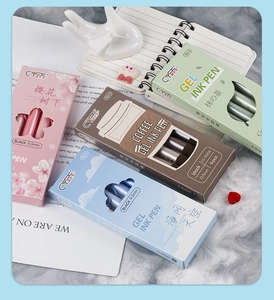 Close-up of 0.5mm black ink gel pen sets in floral and minimalist themed packaging