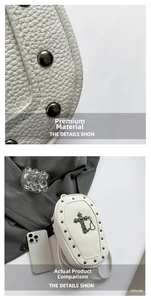 Macro shot showing white litchi pattern leather texture and metal cross charm on the bag