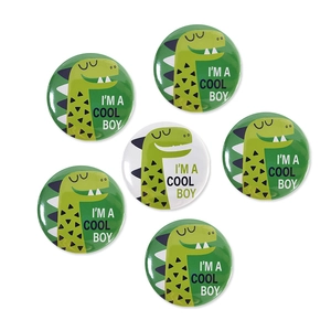 Set of cartoon dinosaur tinplate badges featuring Cool Boy text on white background