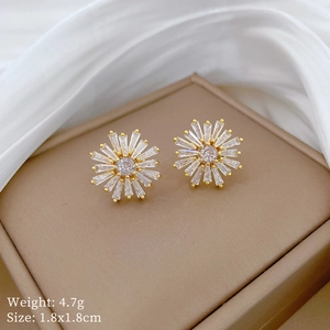 Detail view of gold snowflake earrings with micro-inlaid cubic zirconia, 1.8x1.8cm size