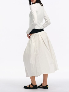 Minimalist white long-sleeved cardigan and matching midi skirt set for elegant women