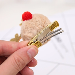 Brown reindeer antler hair clip with red pompom and gold metal duckbill clip detail