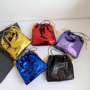 Top view of sequined drawstring bucket bags in gold, red, purple, blue, and black