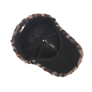 Detail view of winter baseball cap showing leopard faux fur trim and black twill lining