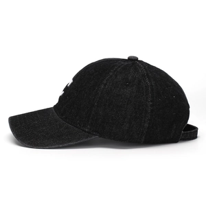 Close-up of vintage black denim baseball cap featuring 3D white letter C embroidery