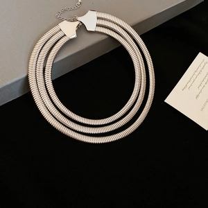 Detail of silver triple-layer snake chain necklace with lobster clasp and extension