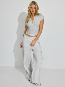 Detail of grey ribbed knit top with buttoned Henley V-neck and soft textured fabric