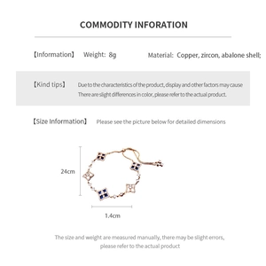 Detail of adjustable gold bracelet featuring blue zircon and abalone shell clover motifs