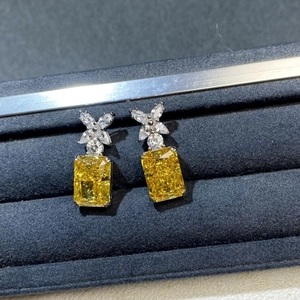 Macro shot of S925 silver studs with yellow radiant cut stone and floral crystal top