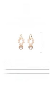 Detail view of S925 silver 18K gold heart earrings with natural freshwater pearls and specs