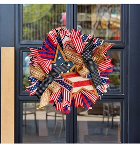 Detailed view of patriotic US wreath with stars and stripes ribbons on a glass door