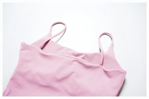 Close-up of pink brushed yoga vest showing elastic fabric and fine shoulder straps