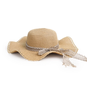 Detailed close-up of beige straw sun hat with wavy brim and delicate lace ribbon
