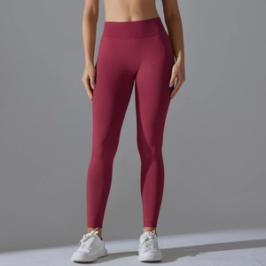 Detail view of wine red seamless yoga pants with high waist ribbed waistband and firm fit