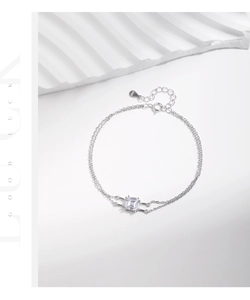Macro view of S925 sterling silver double-layer bracelet with square crystal and heart tag