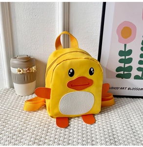 Detail of yellow cartoon duck toddler backpack with 3D orange beak and adjustable straps