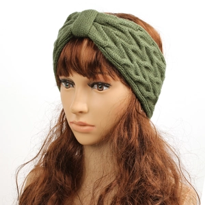 Detailed knit texture of green cable knit headband for women on a white model head