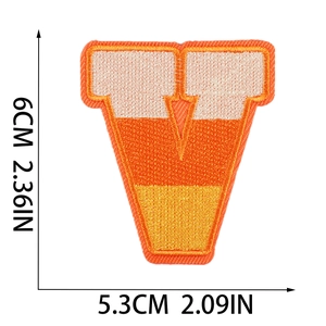 Detail of letter V Halloween patch with orange gradient embroidery and size dimensions