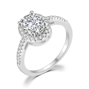 Close-up of an oval-cut AAA zircon halo engagement ring with a micro-pave silver band