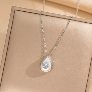 Elegant silver teardrop necklace with heart-shaped zircon pendant on jewelry box