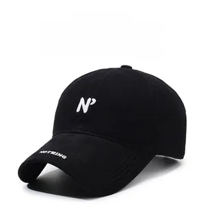 Close-up of N^7 white embroidery on black washed cotton baseball cap with curved brim