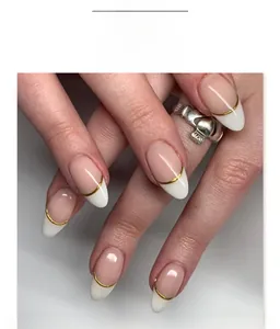 Short almond press-on nails featuring French white tips and delicate gold line details