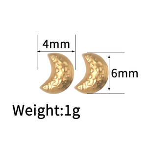 Detail view of gold crescent moon earrings with 18K plating and hammered texture surface