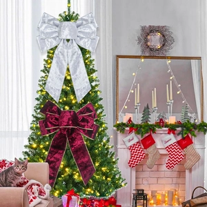 Velvet Christmas bows in silver and burgundy decorating a festive holiday tree