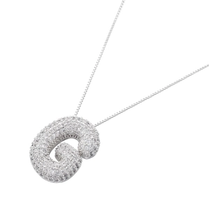 Macro shot of silver bubble letter G pendant necklace with full cubic zirconia stones
