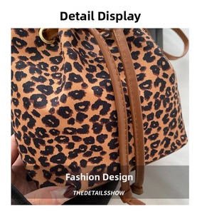 Macro shot of leopard print canvas bucket bag showing stitching and drawstrings