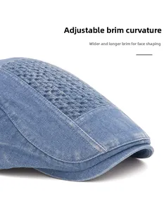 Detail of blue denim flat cap featuring foldable wide brim and woven top panel design