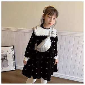 Silver quilted crossbody chest bag paired with a black velvet dress on a child model