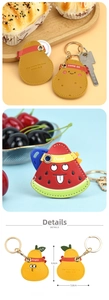 Close-up of cute pear-shaped PU leather key case with neat stitching and metal ring