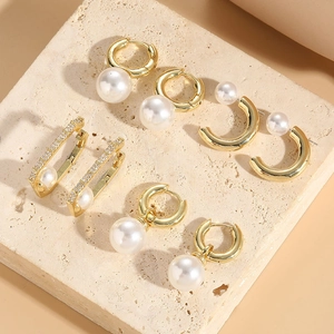 Bohemian gold-plated earrings collection with pearls and zircon on stone display