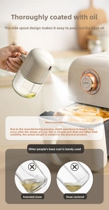 Detail view of the angled straw and spray mechanism of the kitchen glass oil dispenser bottle.