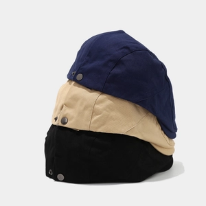 Detailed view of quick-dry cotton flat caps in navy blue, khaki, and black with metal snaps