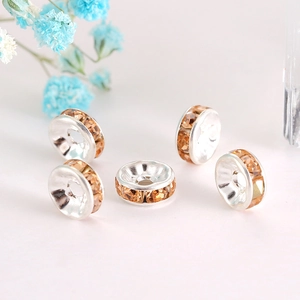 Detailed macro view of five champagne crystal spacer beads for DIY jewelry making
