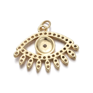 Macro view of gold evil eye pendant featuring sparkling eyelashes and clear zircon stones