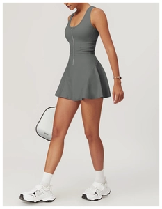 Close-up of front zipper and pleated hem on a dark grey sleeveless athletic tennis dress
