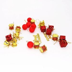 Set of 26 red and gold Christmas tree ornaments including bells, drums, and gift boxes
