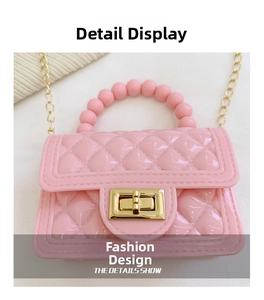 Detailed close-up of pink quilted PVC jelly bag with pearl handle and golden twist lock