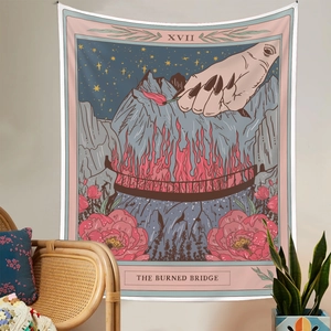 Detail of tarot style The Burned Bridge tapestry hanging over a lounge chair in a room