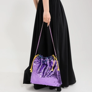 Detail of purple sequin bucket bag featuring a colorful woven chain strap for women