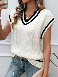 Detail of V-neck cable knit sweater vest with black stripes on white sleeveless top