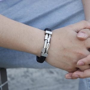 Punk style men's black braided leather bracelet with stainless steel metal links on wrist