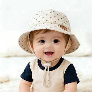 Baby cotton sun hat with gray polka dots, wide brim, and adjustable windproof strap