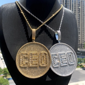 Detailed view of CEO letter pendants in gold and silver with zircon stone inlay